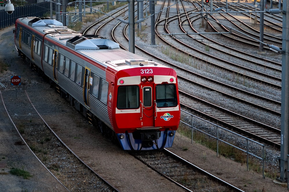 red and white train on train station