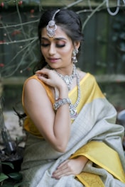 woman in yellow sleeveless dress wearing gold necklace