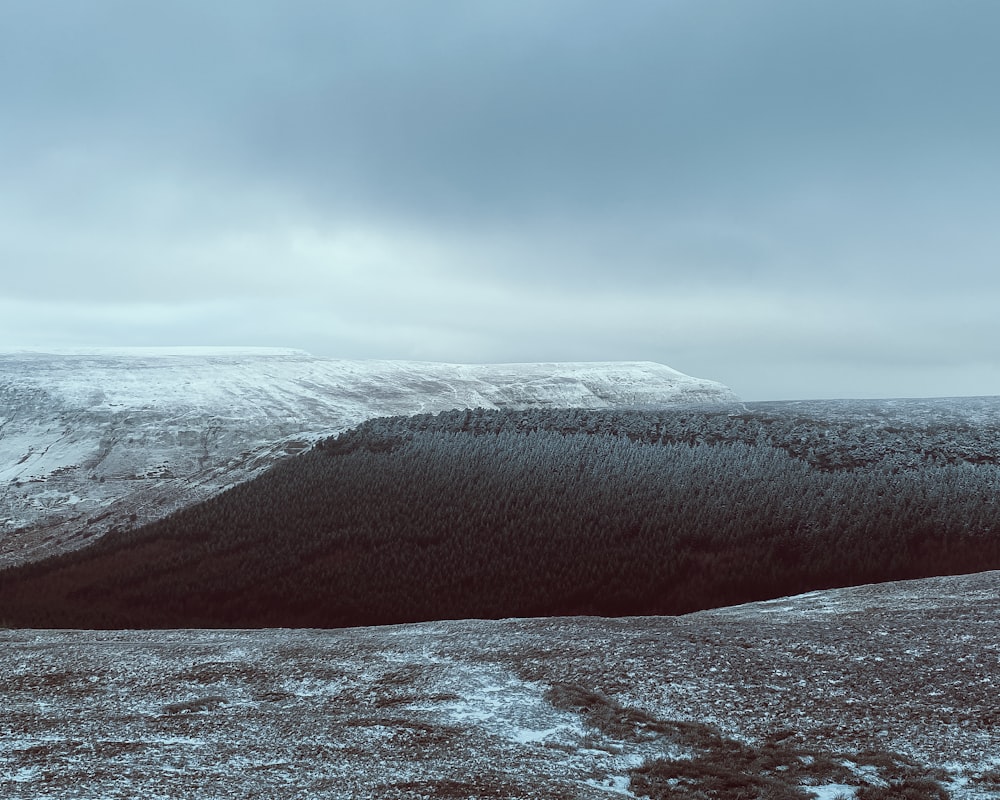 brown mountain under white clouds during daytime