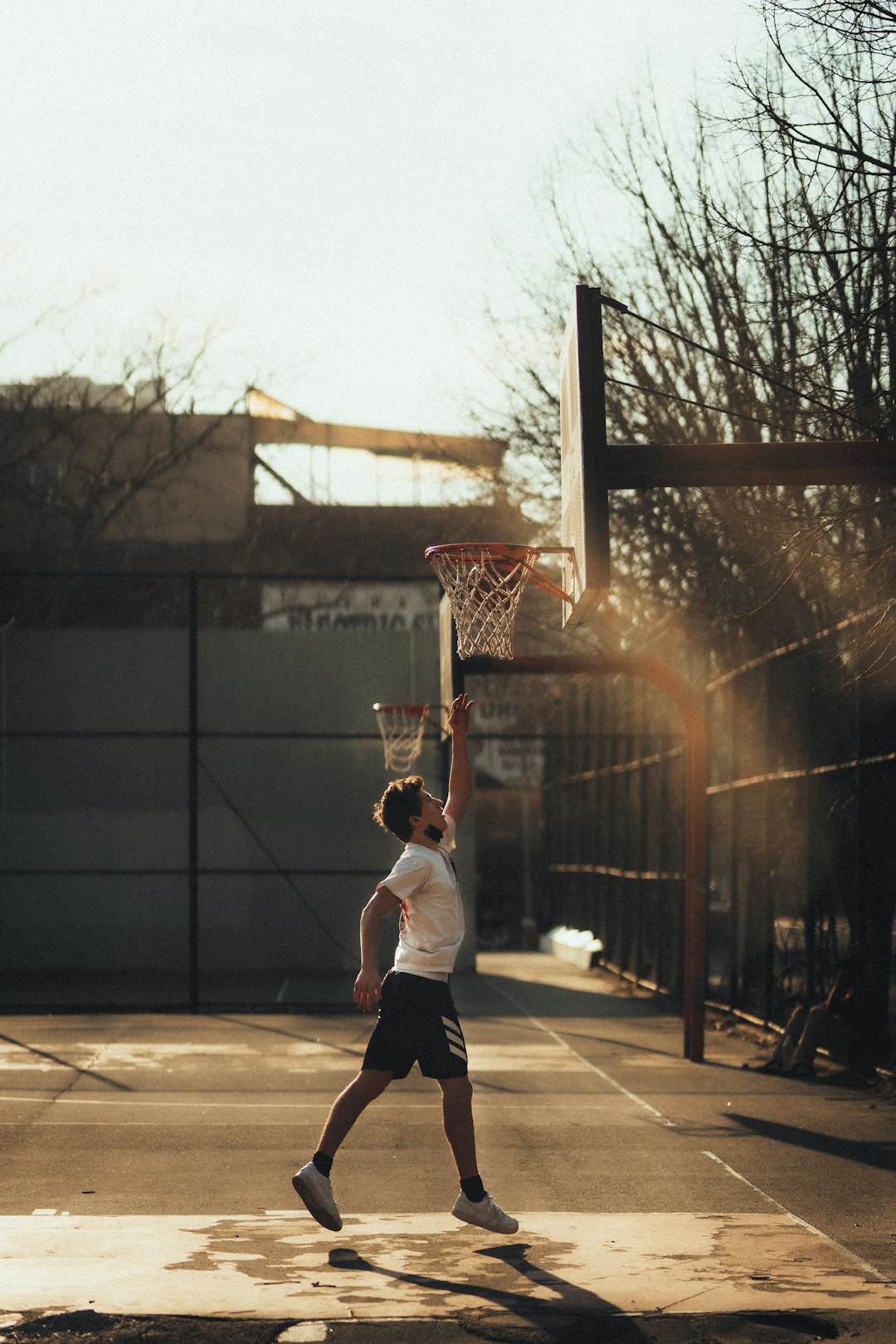 man in white t-shirt playing basketball