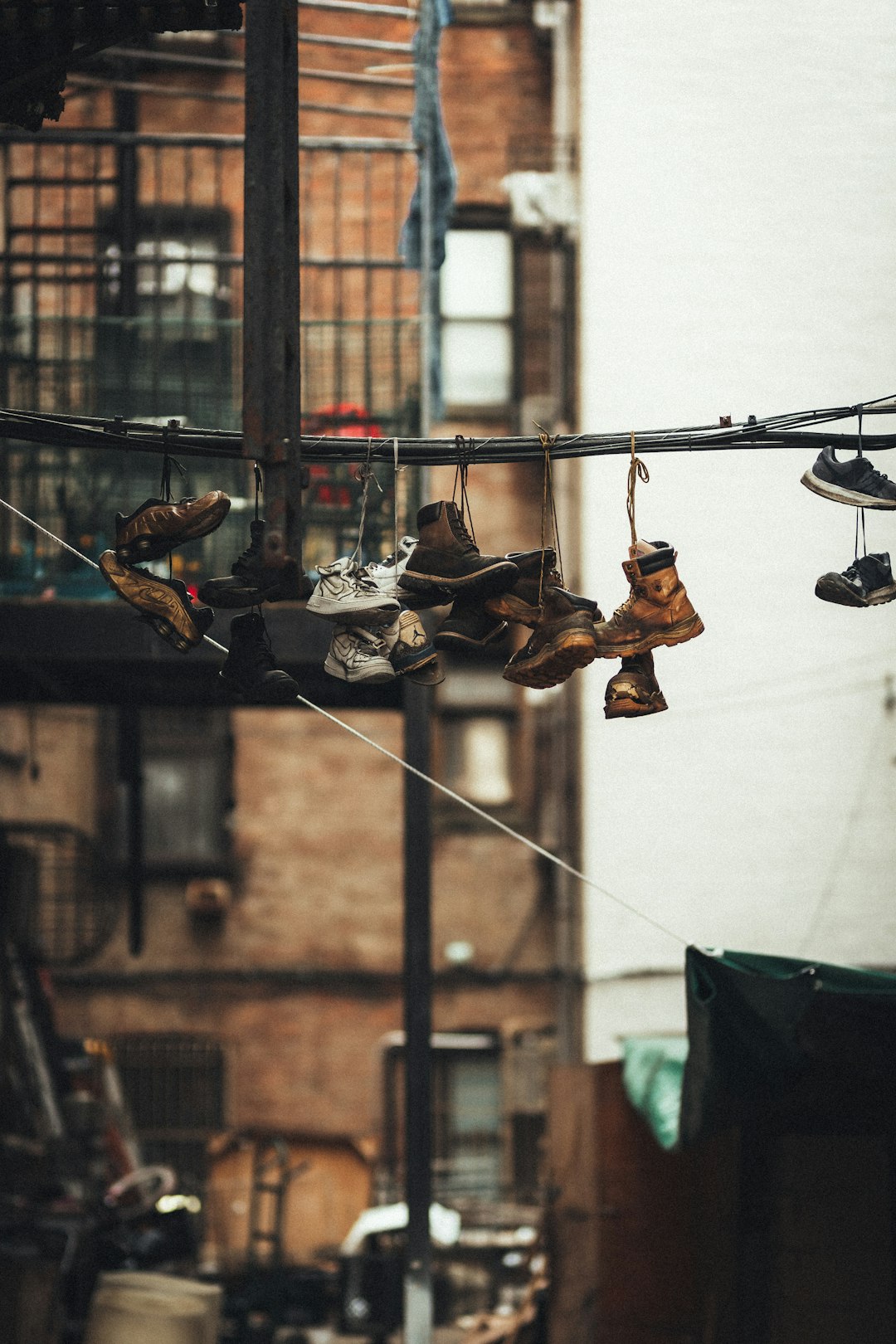 brown leather boots hanged on black metal wire