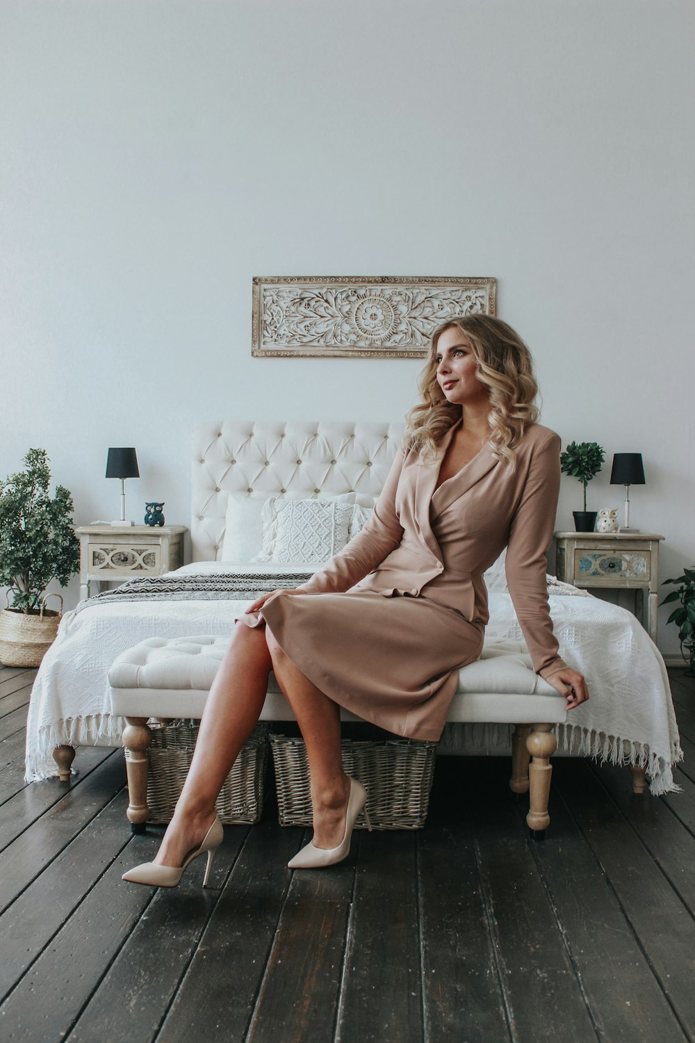 woman in pink long sleeve dress sitting on white bed