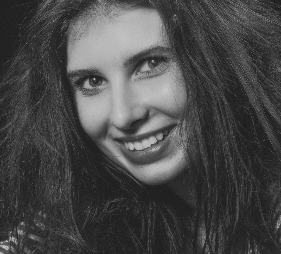 smiling woman in black and white