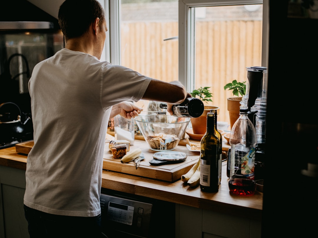 man in white shirt holding wine glass