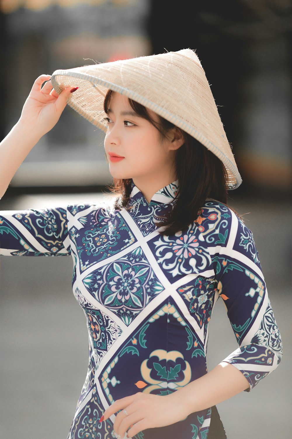 woman in blue and white floral long sleeve shirt wearing brown sun hat