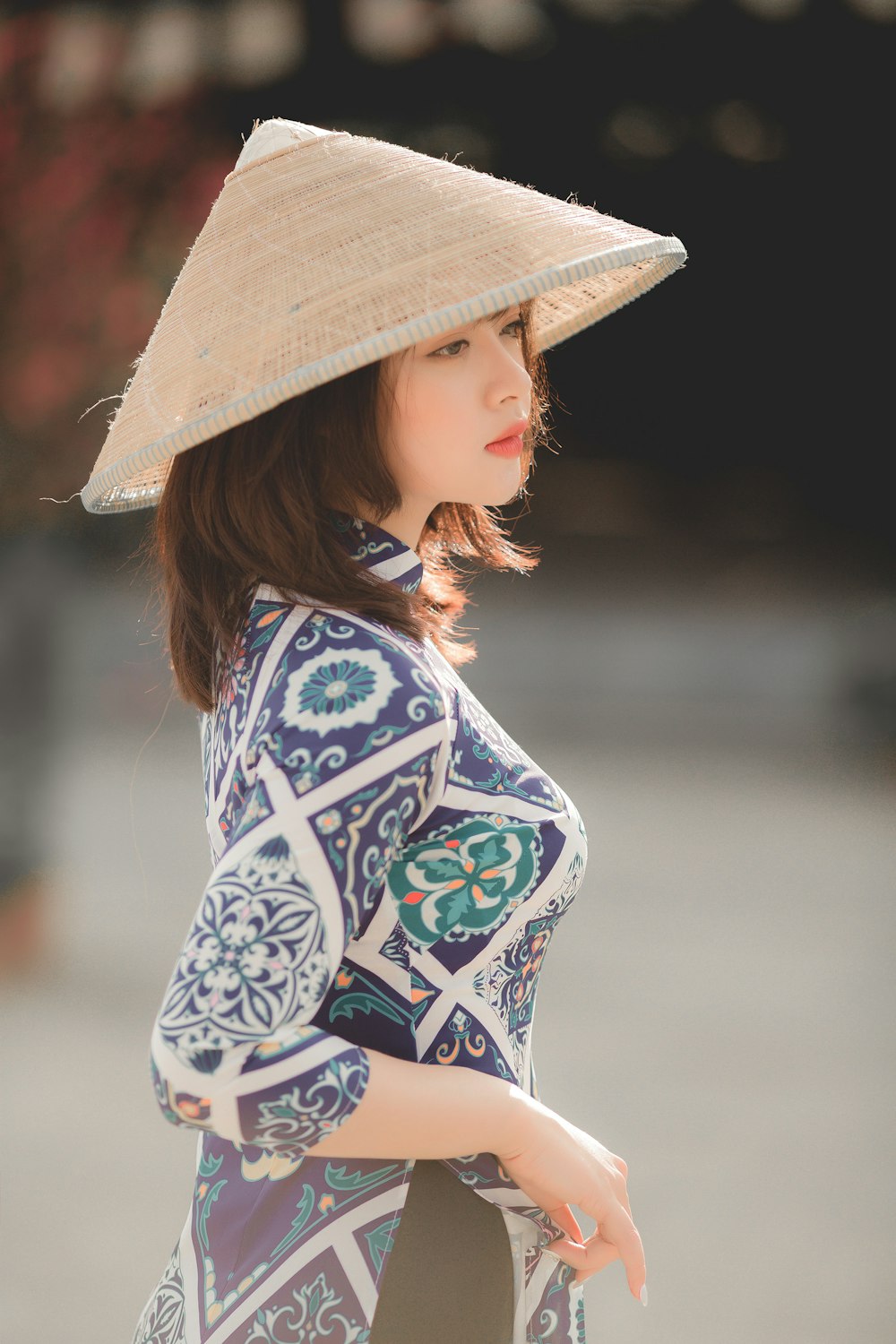 woman in blue and white floral long sleeve shirt wearing brown hat