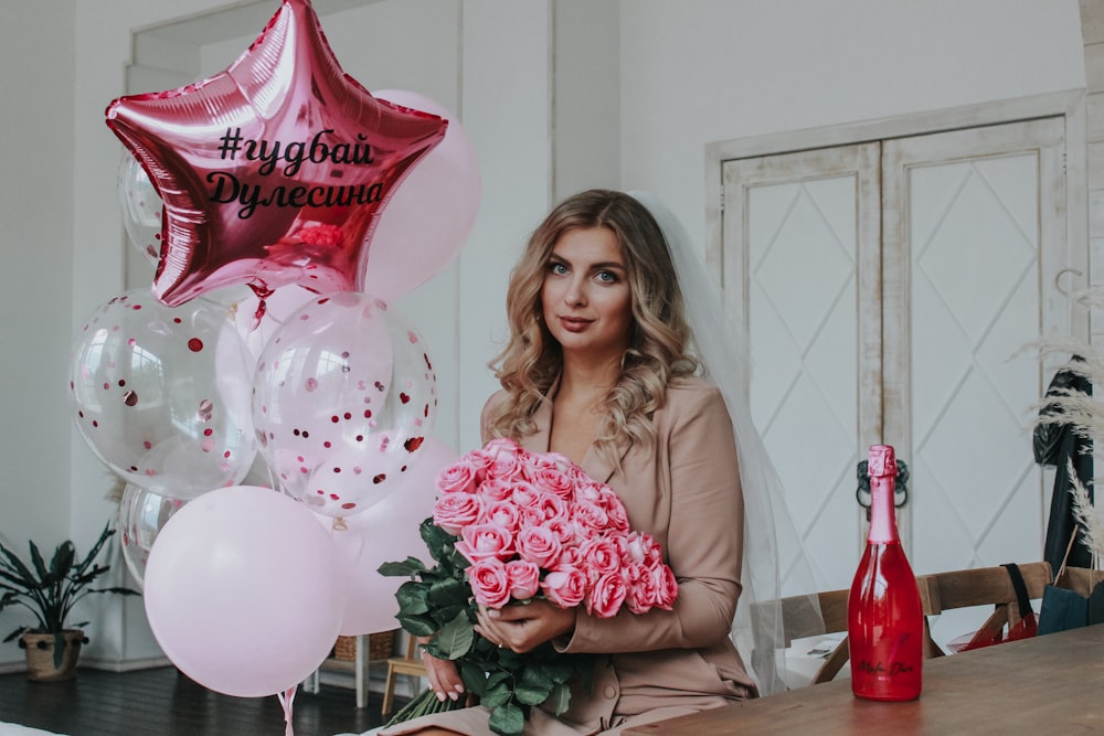 woman in pink dress holding bouquet of flowers