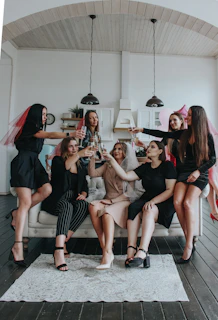 group of women sitting on white floor