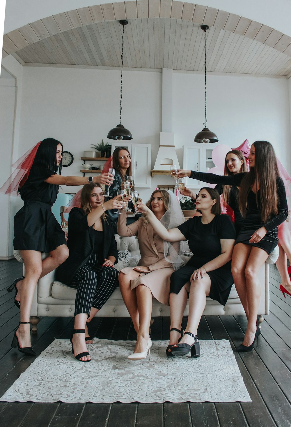 group of women sitting on white floor