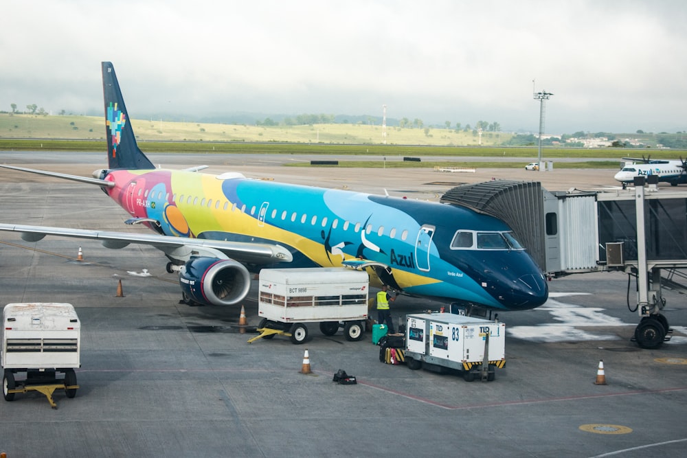 white and blue passenger plane on airport during daytime