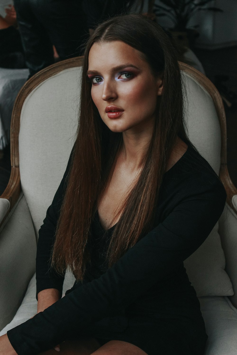 woman in black long sleeve shirt sitting on gray chair