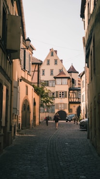 people walking on sidewalk near buildings during daytime