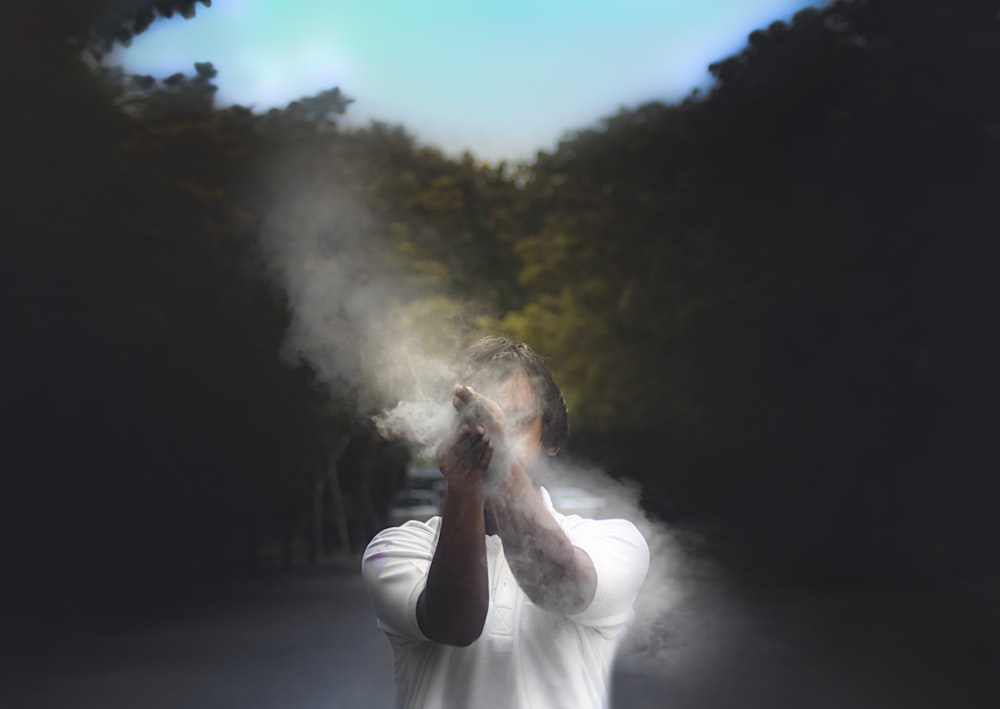 man in white t-shirt smoking