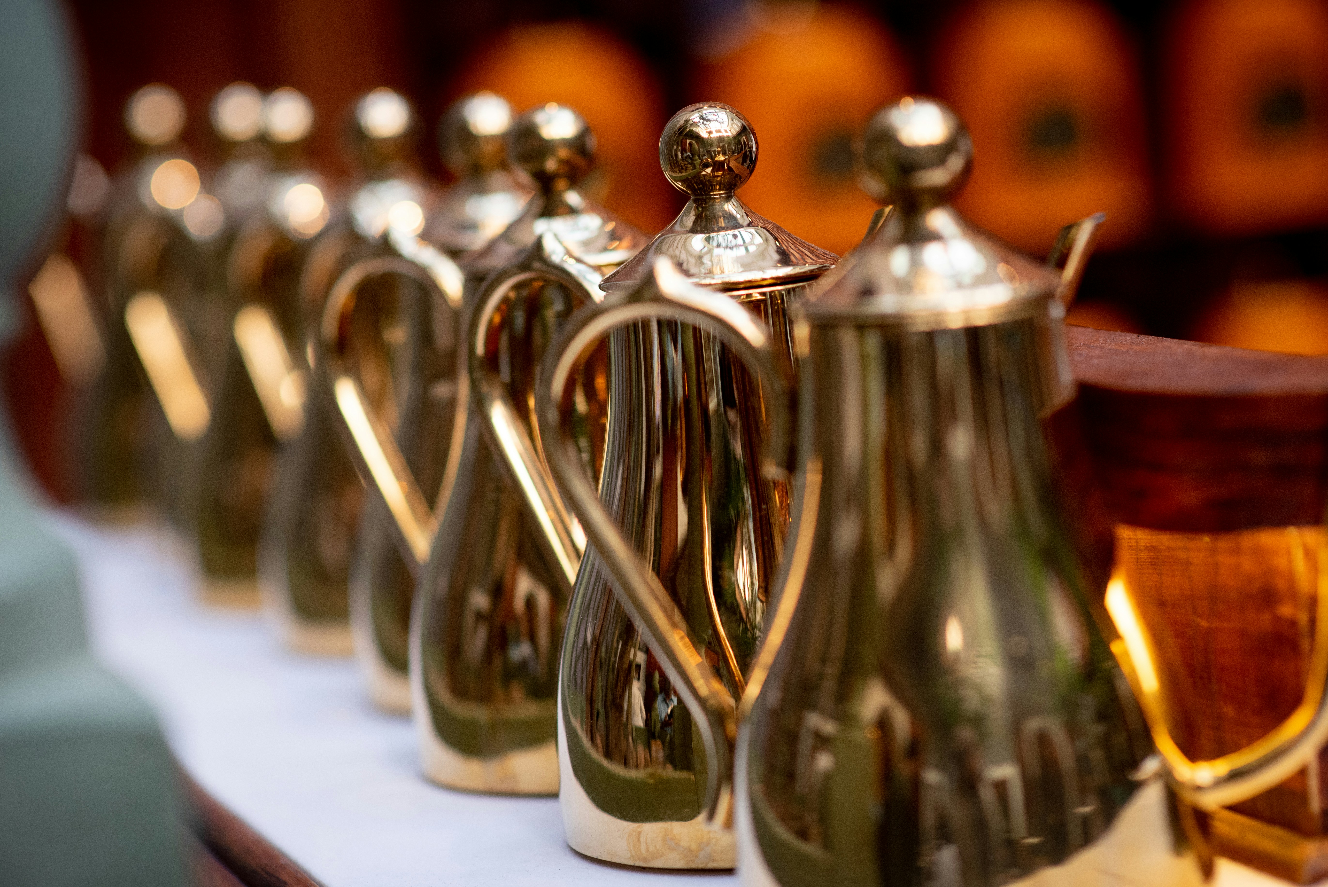 stainless steel teapot on white table, Shiny arabic coffee pots lined up at the shop in Marrakech, Morocco - ready to serve customers who are looking for a break from touring the medina