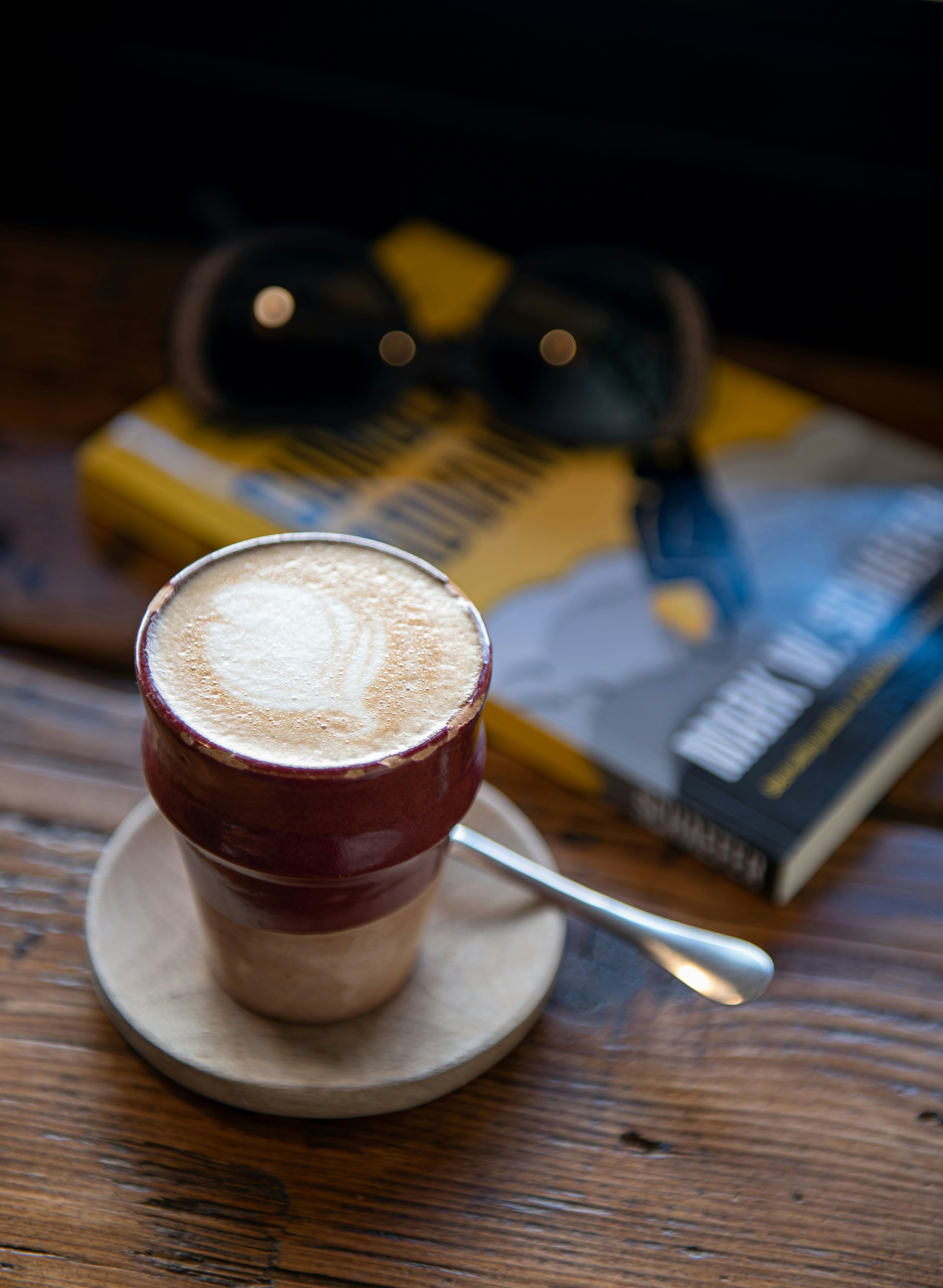 brown and white ceramic mug on white ceramic saucer