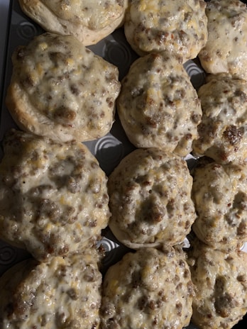 Country gravy smothered sausage skillet with biscuits on the side.
