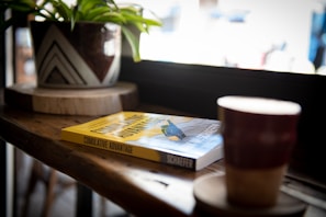 The Leadership Cosmos book displayed on a wooden desk alongside a cup of coffee and notes, inviting readers to dive in.