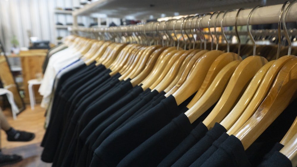 blue and yellow clothes hanged on white metal rack