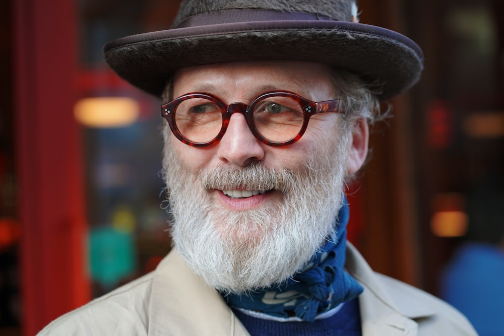 man in brown coat wearing black framed eyeglasses