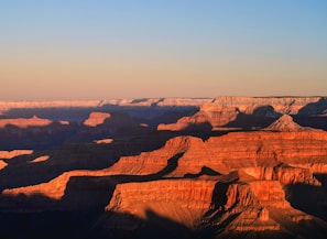 A vibrant sunrise over the Grand Canyon highlighting layers of red rock.