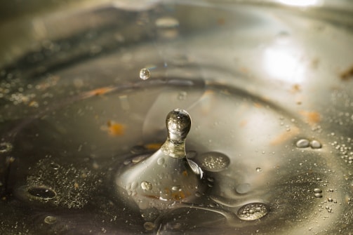 Close-up of water droplets rippling on a glass surface.