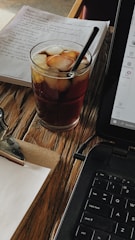 A coach reviewing a proposal draft with notes and a coffee cup nearby.