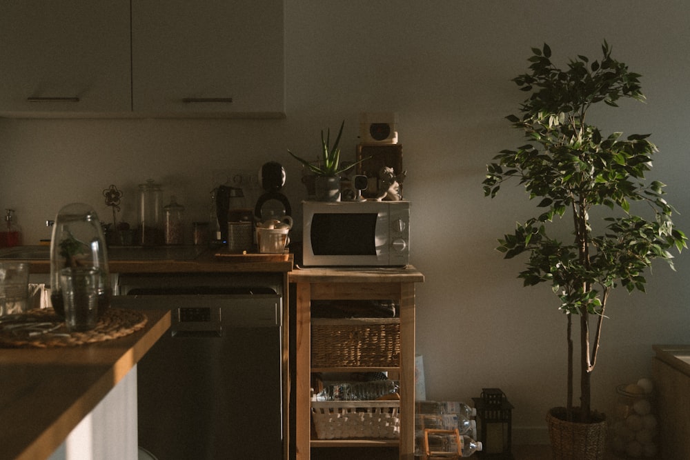 silver microwave oven on brown wooden kitchen cabinet