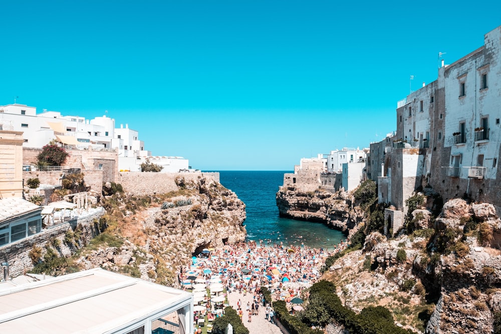 people on beach near buildings during daytime