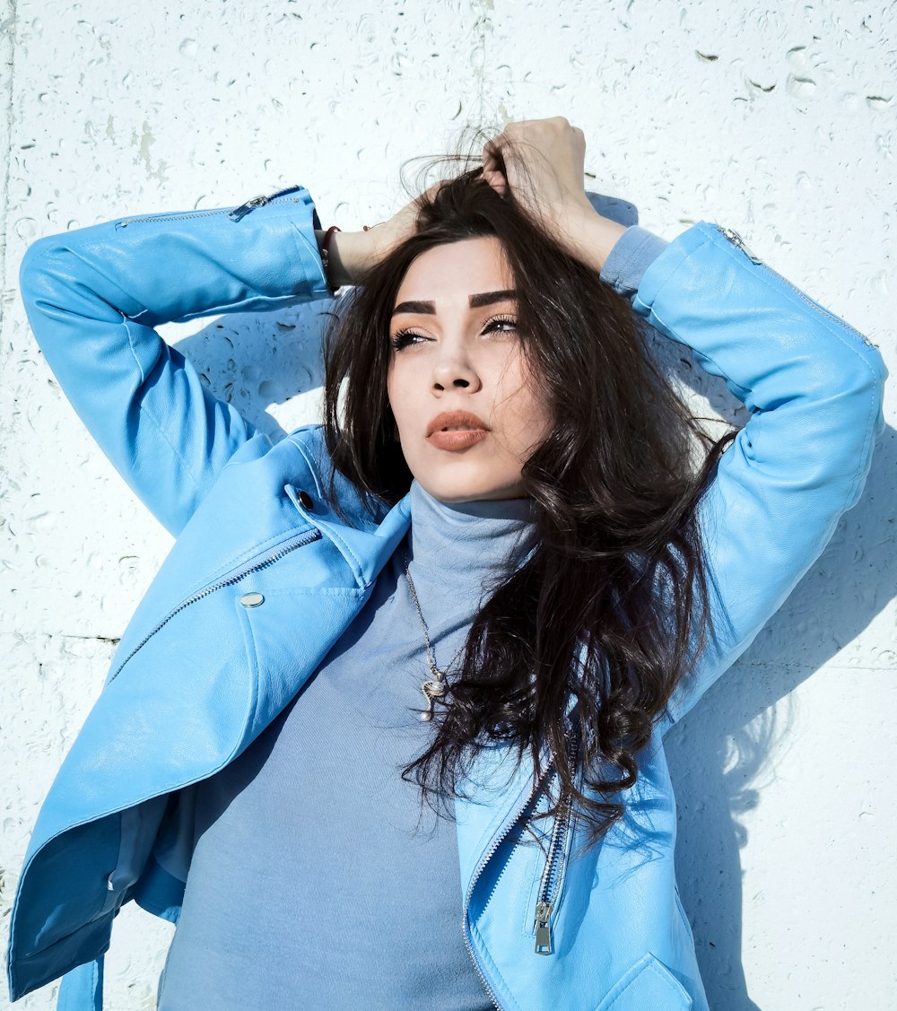 woman in blue jacket standing and smiling