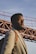 man in gray shirt standing near bridge during daytime