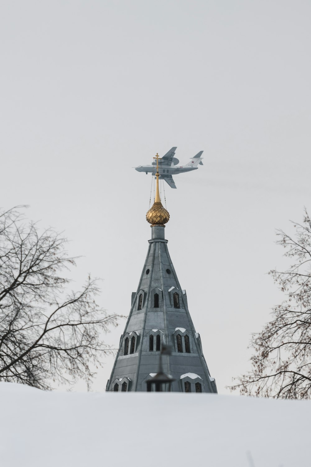 gold cross on top of gray concrete building