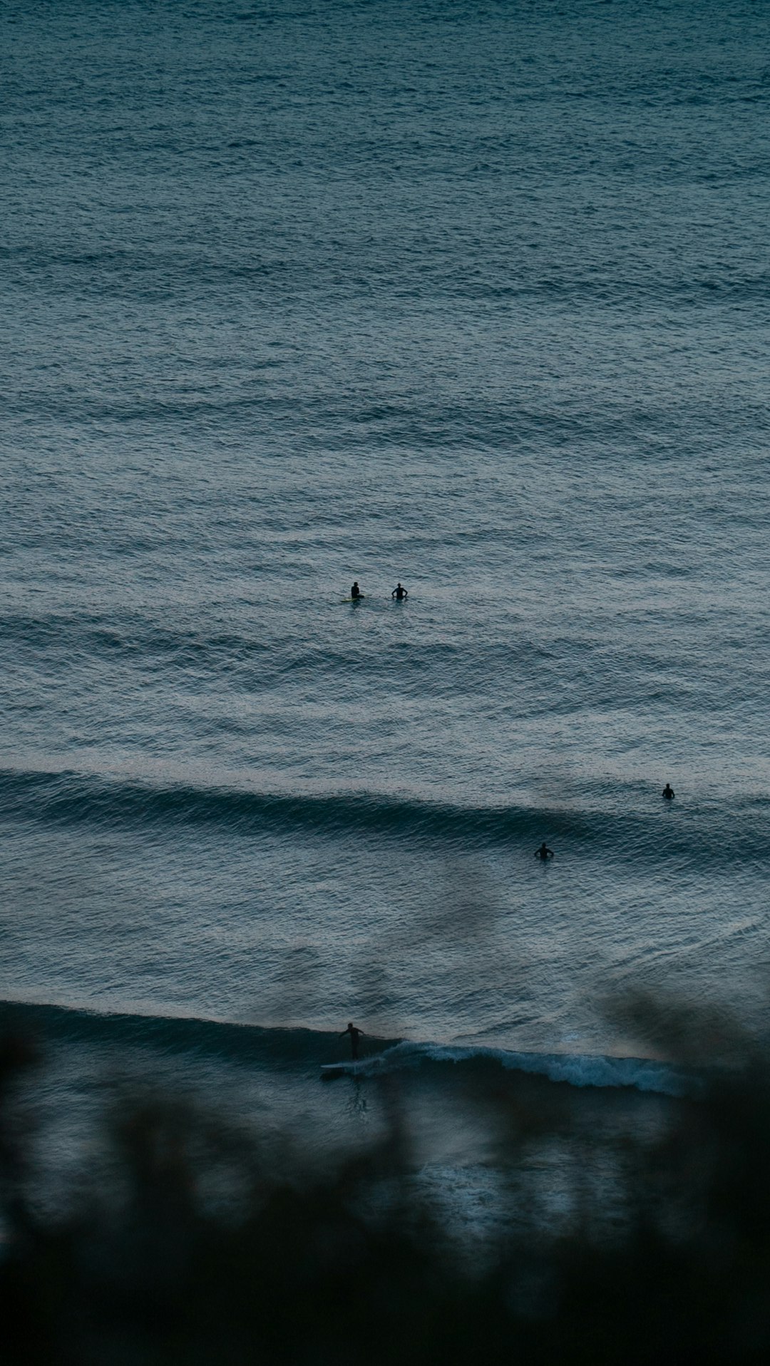 people surfing on sea waves during daytime