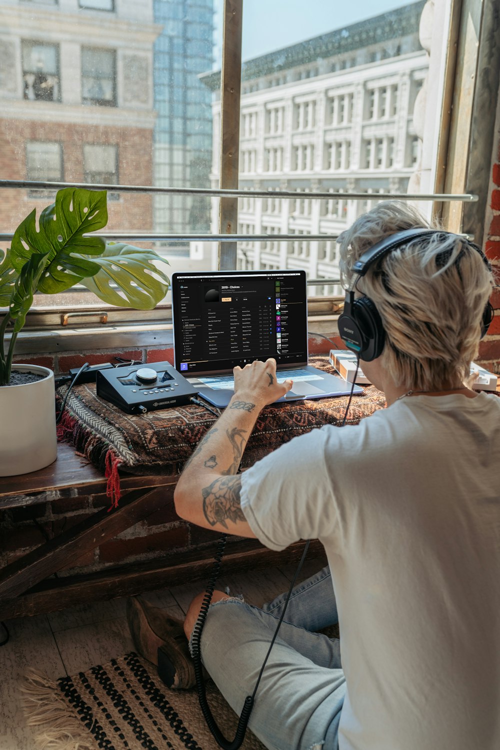 woman in white long sleeve shirt using black laptop computer