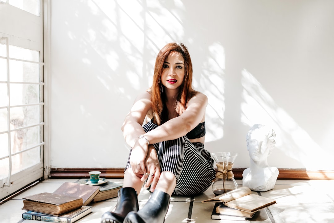 woman in black and white stripe dress sitting on chair