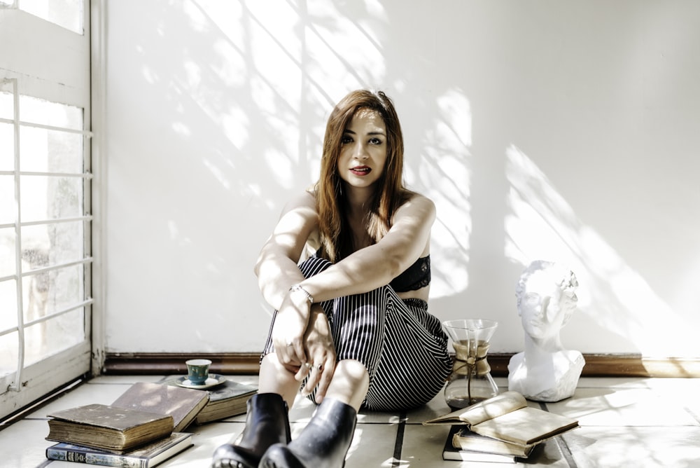 woman in black and white stripe dress sitting on chair