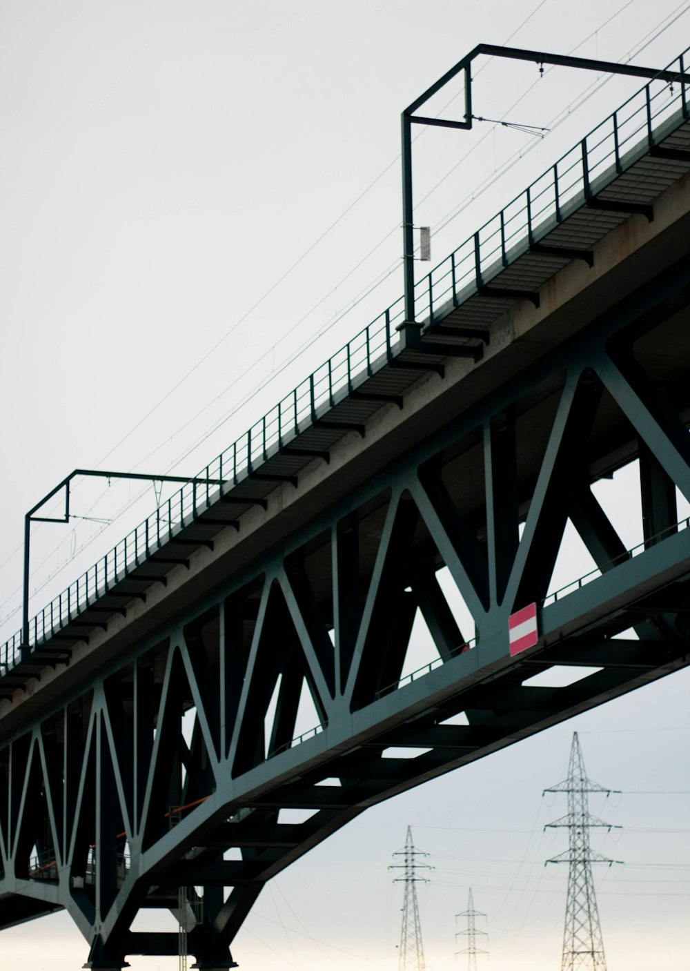 brown metal bridge under white sky during daytime