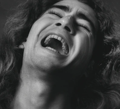 Close-up portrait photo showing emotional expression, in 4:6 format.