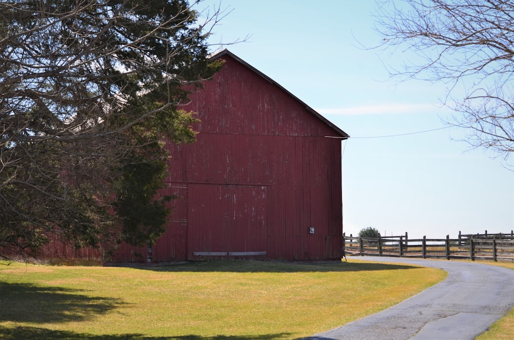 brown wooden barn near bare trees during daytime