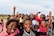 A group of diverse children smiling while participating in an outdoor educational activity.