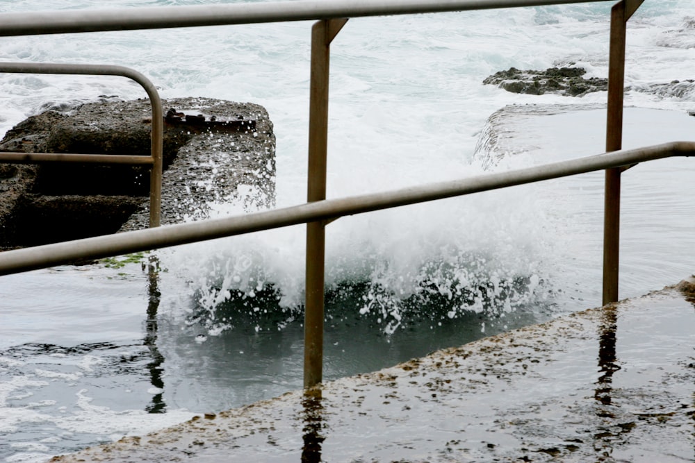 brown wooden railings near body of water during daytime