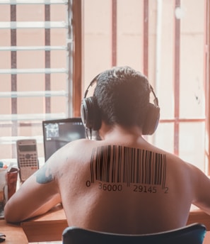 topless man wearing black headphones