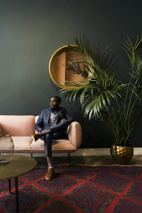 woman in blue denim jacket sitting on white sofa