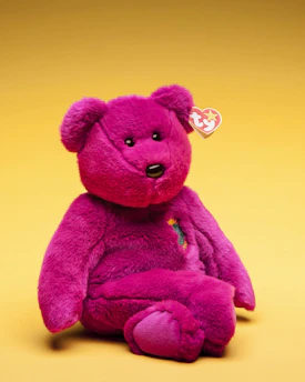 A cozy, custom teddy bear with a heart-shaped patch on its chest.