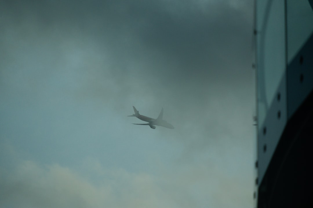 white airplane flying in the sky, Airplane in grey London sky