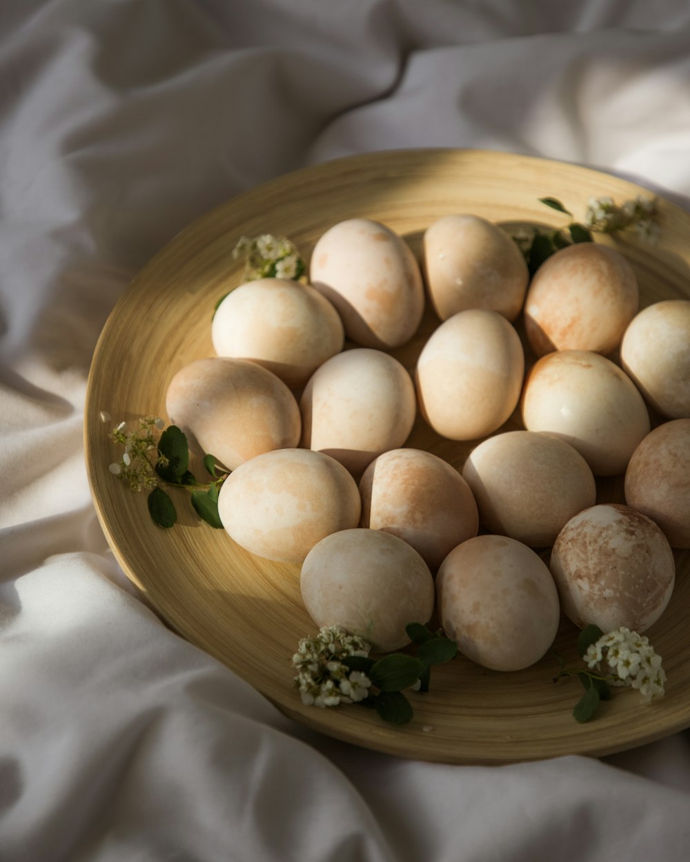 brown round fruit on brown wooden bowl