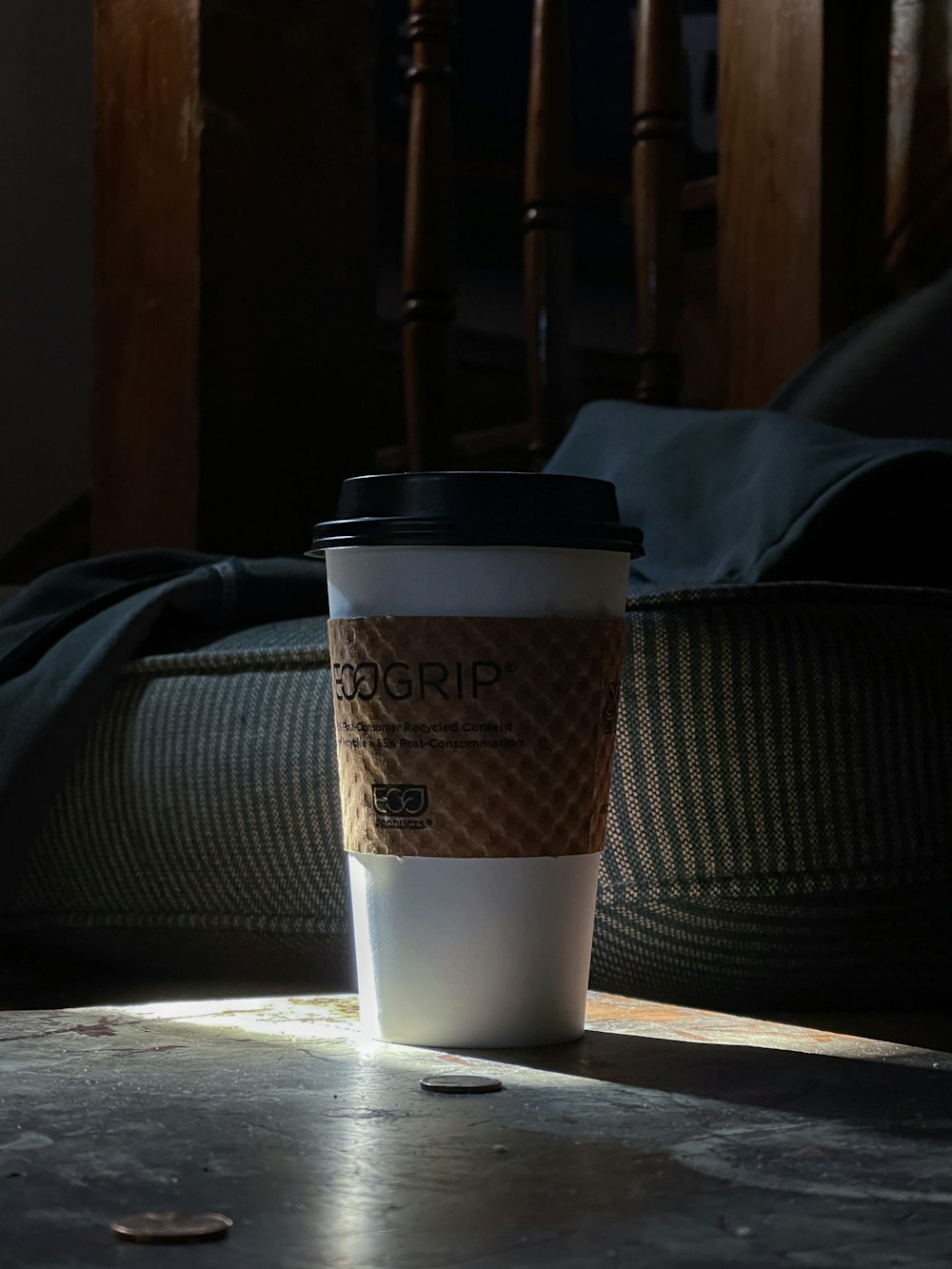 white and black disposable cup on brown wooden table