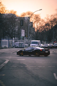 A sleek compact SUV navigating a bustling city intersection at sunset.