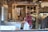 A satisfied restaurant owner giving a thumbs up in front of a clean kitchen.