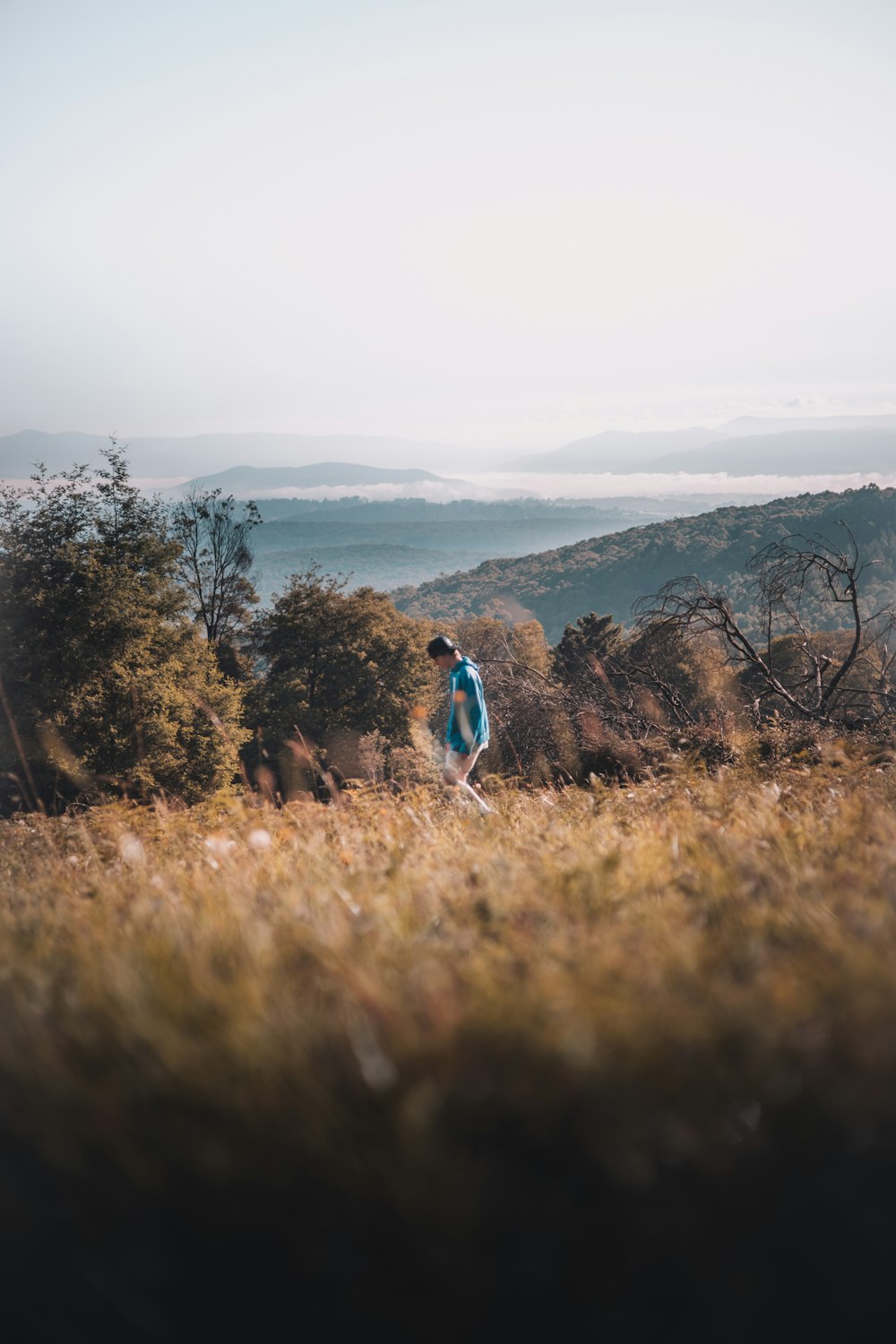 man and woman walking on brown grass field during daytime