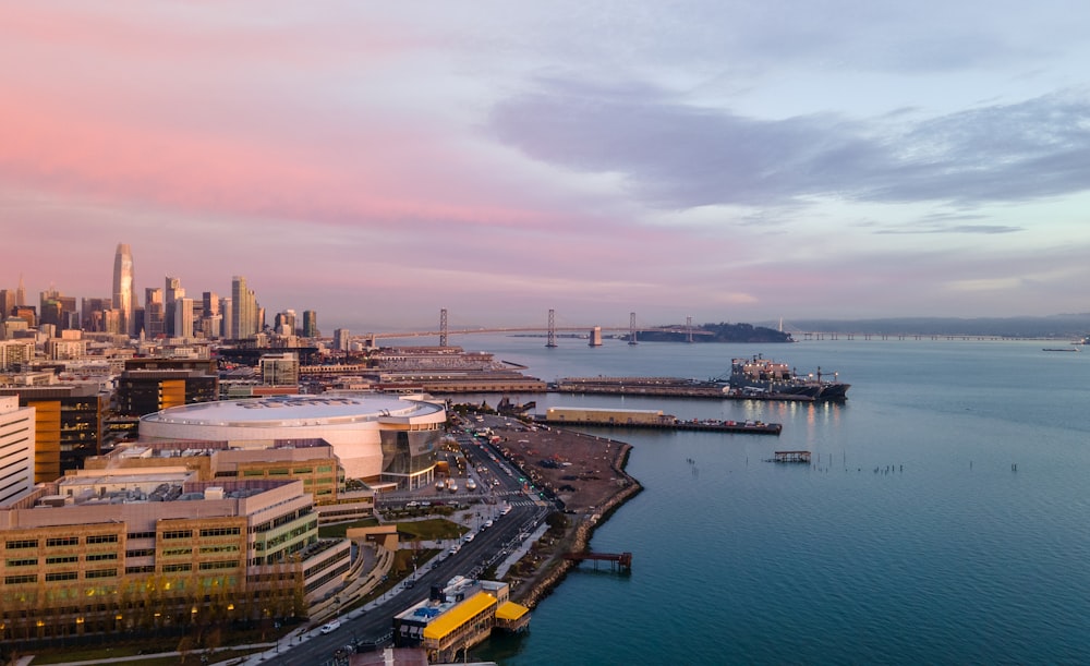 aerial view of city buildings near body of water during daytime